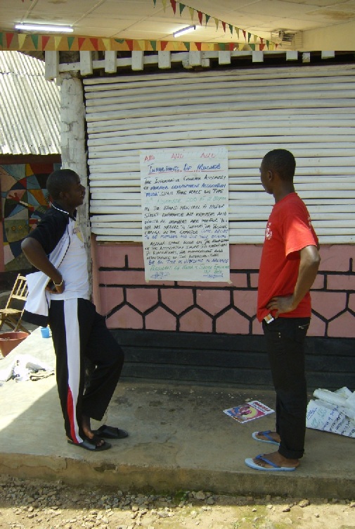 Inhabitant of Ntambag reading information notice